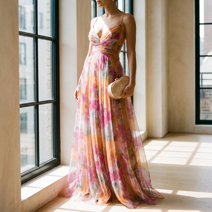 Valerie floral maxi dress by a tall apartment window