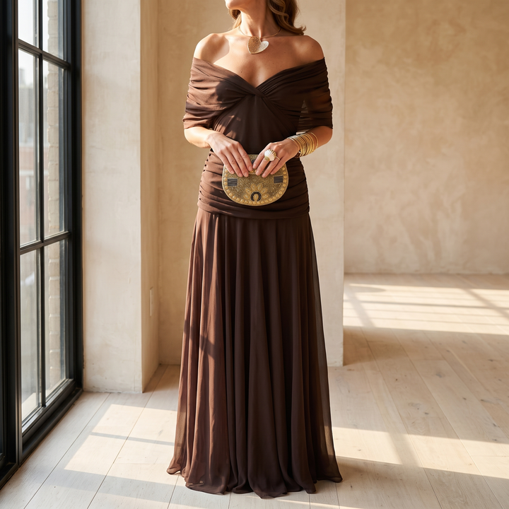 Lisa maxi dress by a tall apartment window