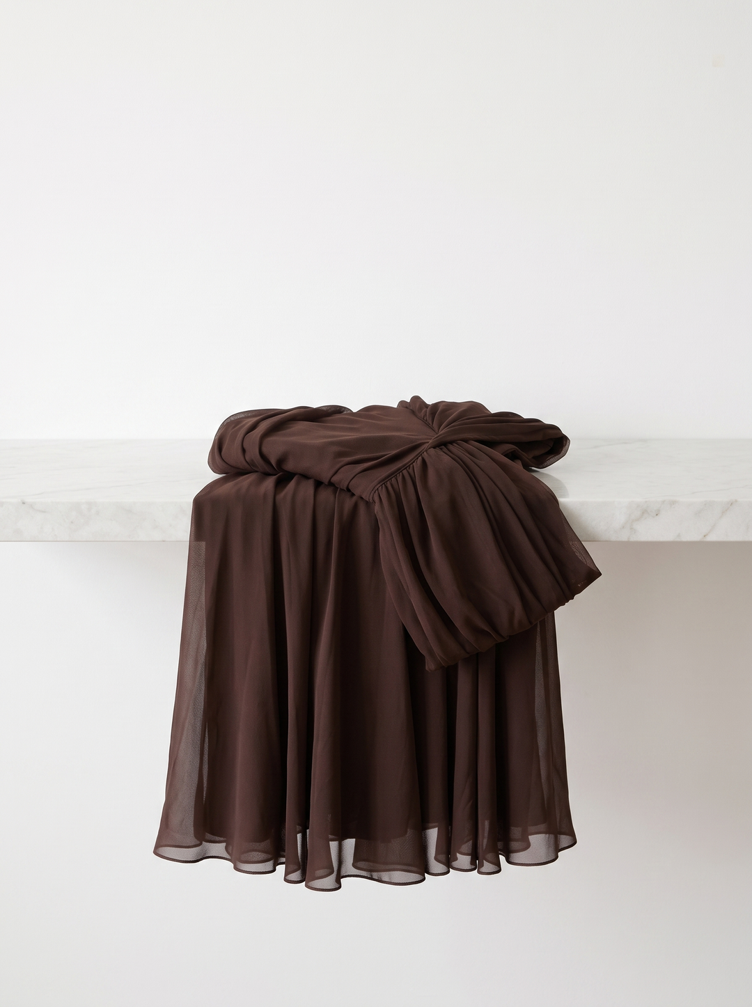 Lisa dress folded over a white counter