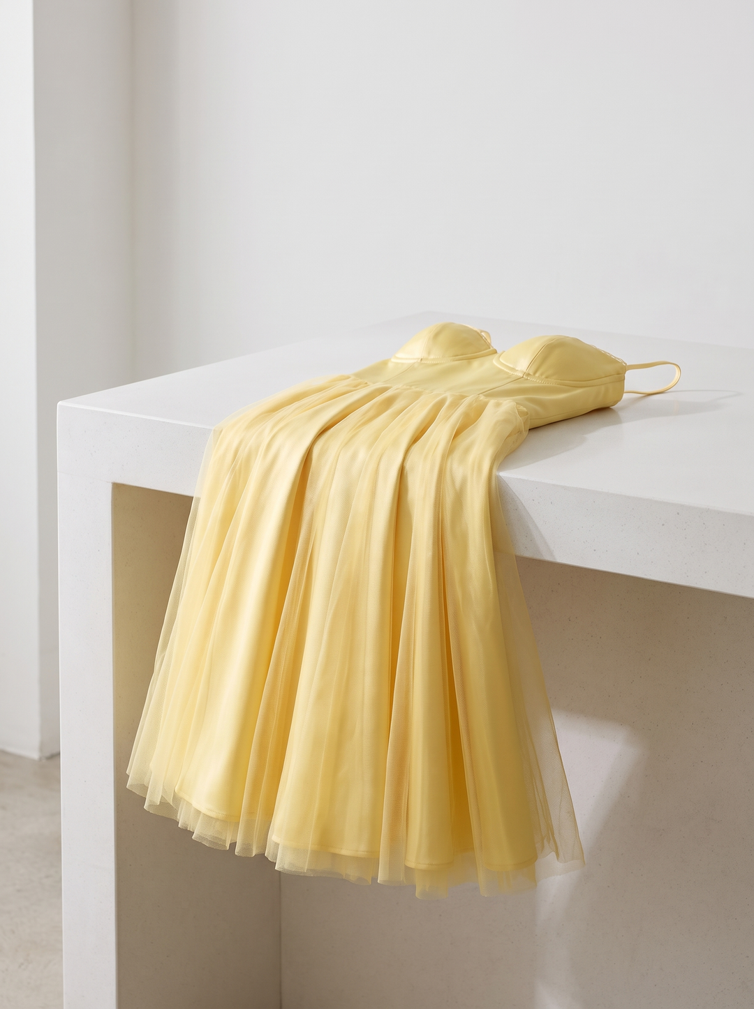 Ophira dress folded over a white counter