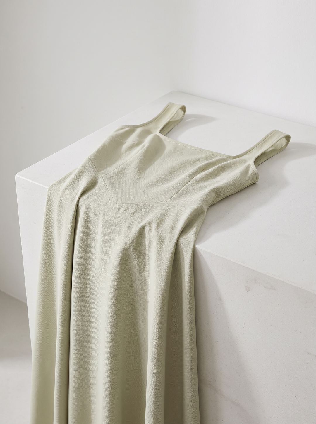 Scarlett dress folded over a white counter