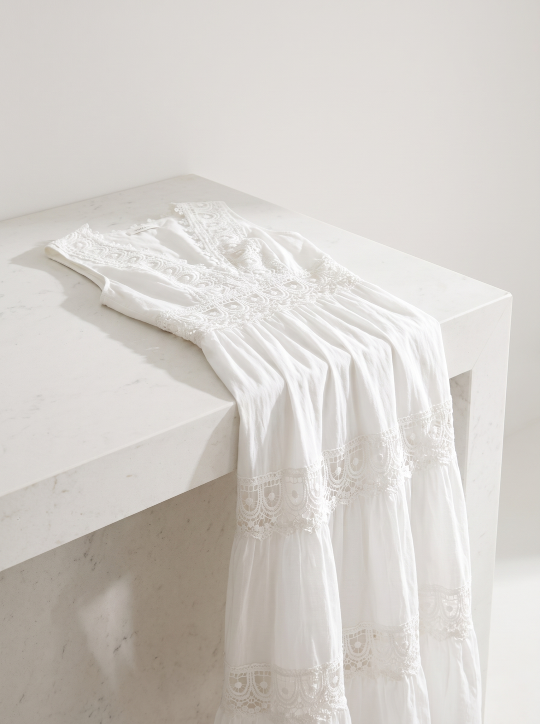 Stella dress folded over a white counter